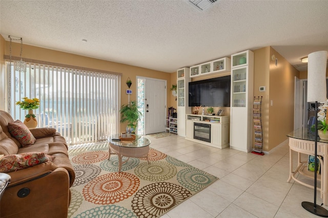 tiled living room featuring a textured ceiling