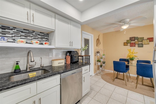 kitchen featuring dishwasher, decorative backsplash, white cabinetry, and sink