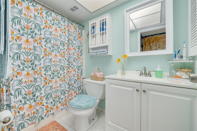 bathroom featuring toilet, vanity, and tile patterned floors