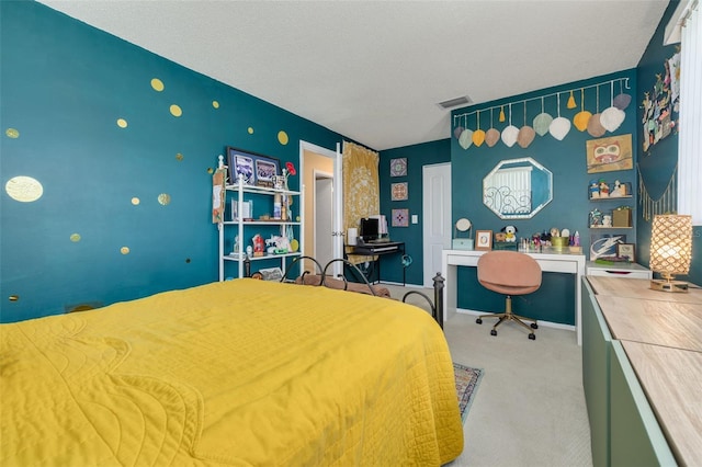 bedroom with a textured ceiling and light colored carpet