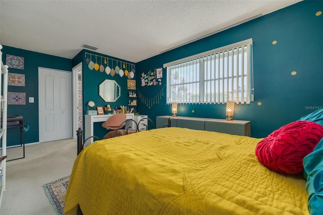 bedroom featuring carpet flooring and a textured ceiling