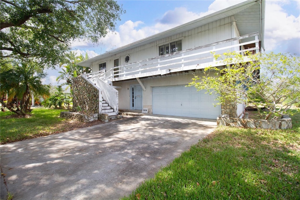 view of property featuring a garage and a front yard