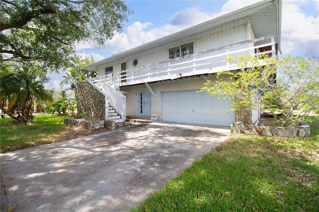 view of property featuring a garage and a front yard