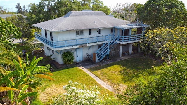 back of house with a lawn and a deck