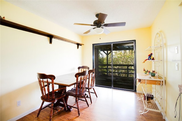 dining area with hardwood / wood-style floors and ceiling fan