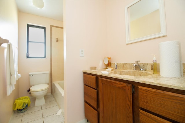 full bathroom featuring tile patterned flooring, vanity, tiled shower / bath, and toilet