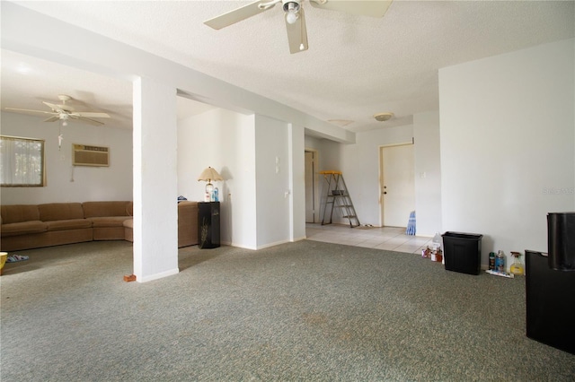 interior space featuring ceiling fan, light colored carpet, a textured ceiling, and an AC wall unit