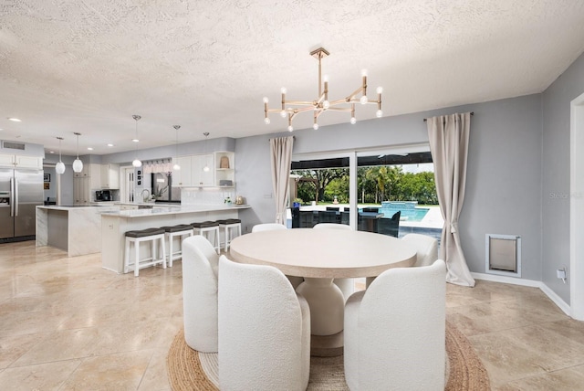 dining room featuring a textured ceiling and a chandelier