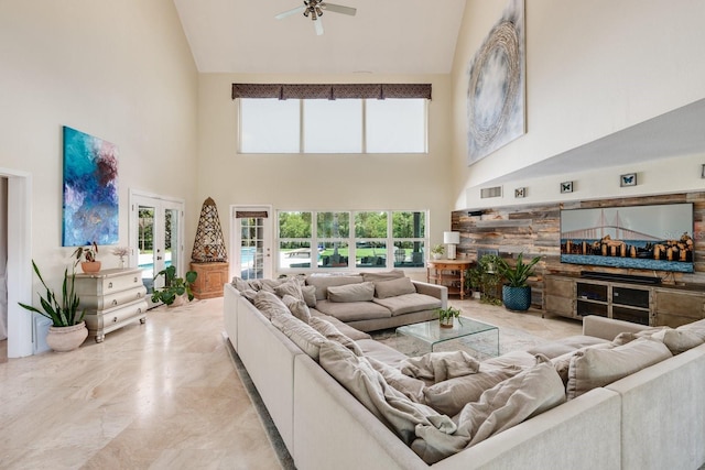 living room with ceiling fan and high vaulted ceiling