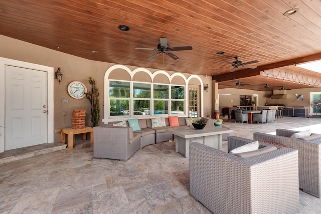 view of patio / terrace featuring outdoor lounge area, a bar, and ceiling fan