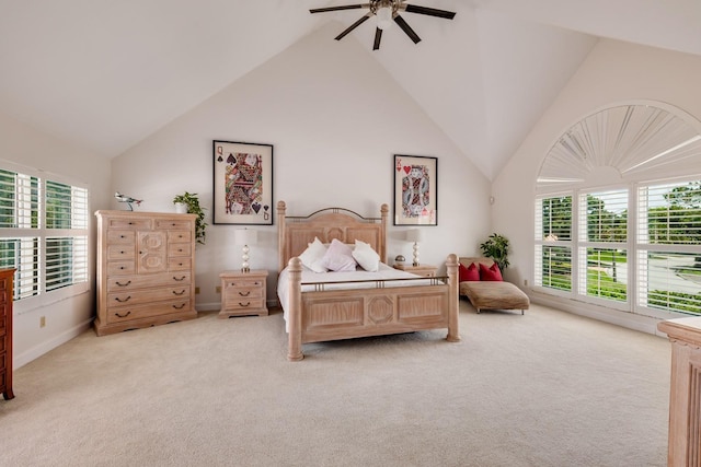 bedroom with multiple windows, ceiling fan, light carpet, and vaulted ceiling