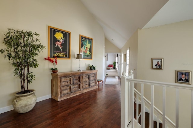 hall featuring dark wood-type flooring and lofted ceiling