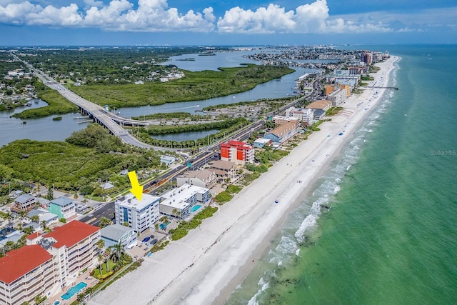 drone / aerial view featuring a water view and a view of the beach