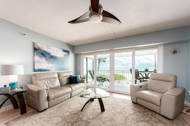 living room with ceiling fan and light hardwood / wood-style flooring