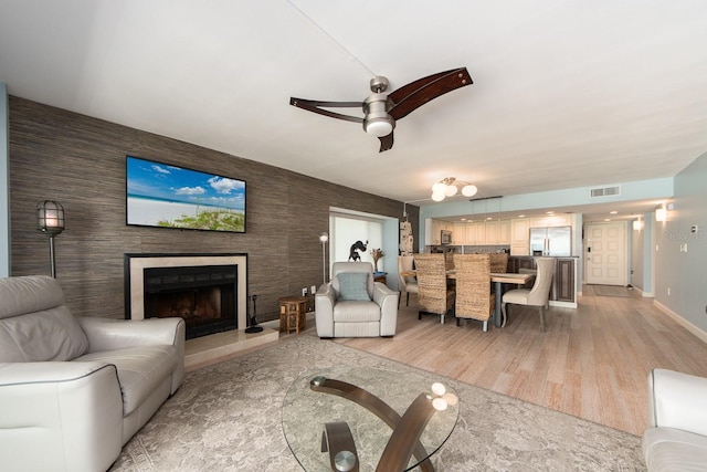 living room featuring ceiling fan and light wood-type flooring