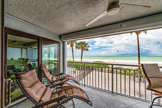 balcony featuring a beach view and a water view