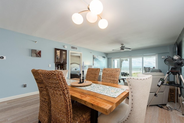 dining space with light wood-type flooring and ceiling fan