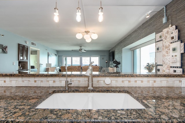 kitchen with plenty of natural light, ceiling fan, and decorative light fixtures