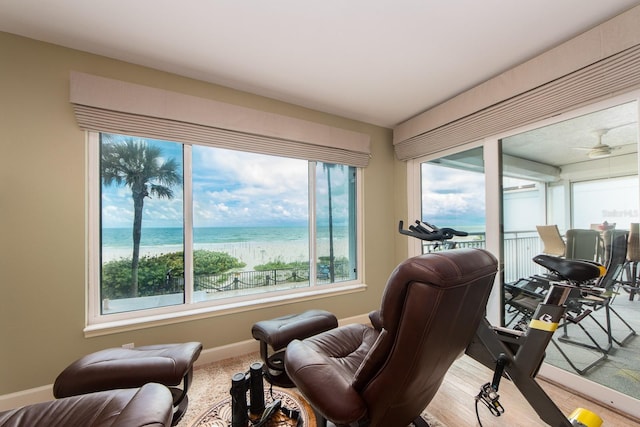 interior space with ceiling fan and a water view