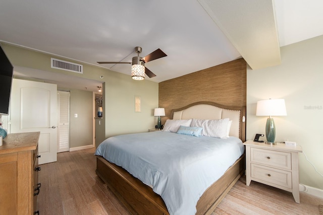 bedroom with light wood-type flooring and ceiling fan