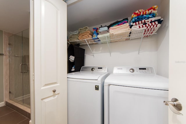 laundry room featuring dark tile patterned flooring and washing machine and dryer