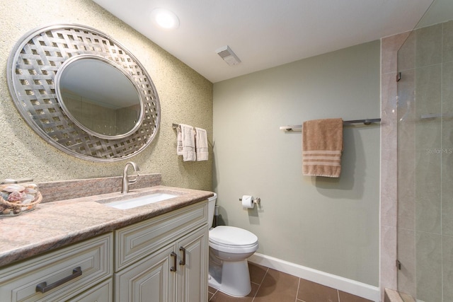 bathroom featuring tile patterned flooring, vanity, and toilet