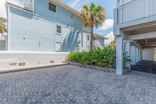 view of side of home with a patio area and a balcony