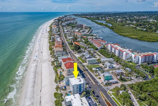 drone / aerial view featuring a water view and a beach view