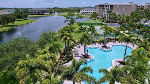 view of swimming pool with a water view and a patio area