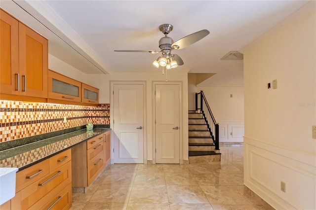 kitchen with light tile patterned flooring, crown molding, decorative backsplash, and ceiling fan