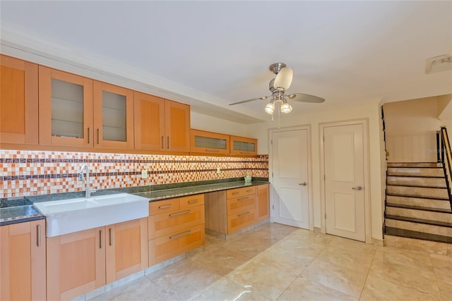 kitchen with sink, light tile patterned floors, ceiling fan, and backsplash