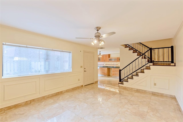 foyer entrance with plenty of natural light, crown molding, light tile patterned floors, and ceiling fan