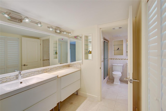 bathroom featuring vanity, tile patterned flooring, toilet, and tile walls