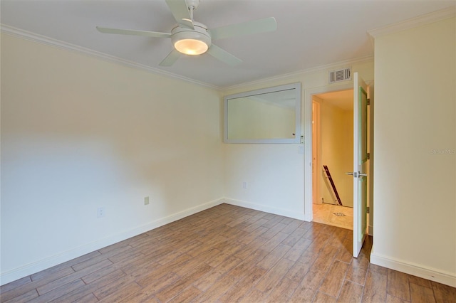 empty room featuring ornamental molding, ceiling fan, and hardwood / wood-style floors