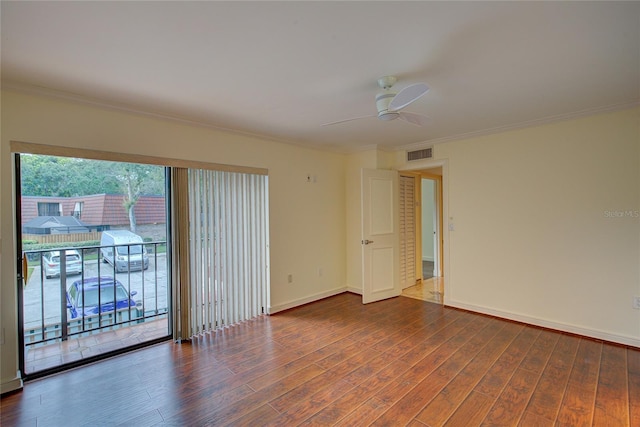 empty room featuring ceiling fan, dark hardwood / wood-style flooring, and ornamental molding