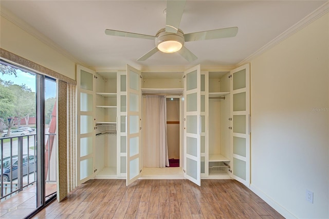 interior space with hardwood / wood-style flooring and crown molding