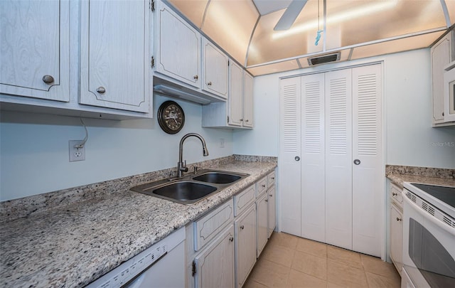 kitchen featuring ceiling fan, white appliances, sink, and light tile patterned floors