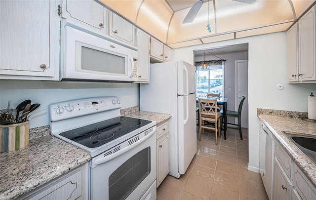 kitchen featuring sink, light stone counters, white appliances, light tile patterned floors, and ceiling fan