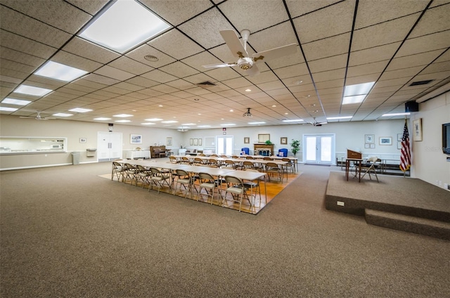 miscellaneous room with carpet flooring and a drop ceiling