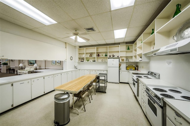 kitchen with ceiling fan, a paneled ceiling, white cabinets, and white appliances