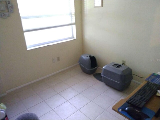 spare room with a healthy amount of sunlight and light tile patterned floors