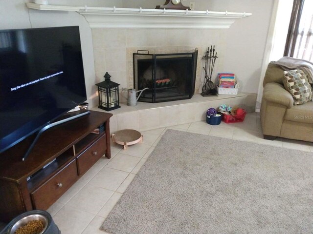 living room with a tile fireplace