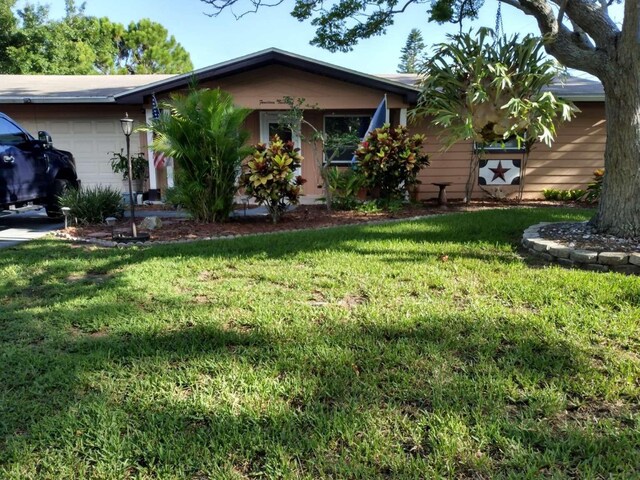 view of front of property featuring a garage and a front yard