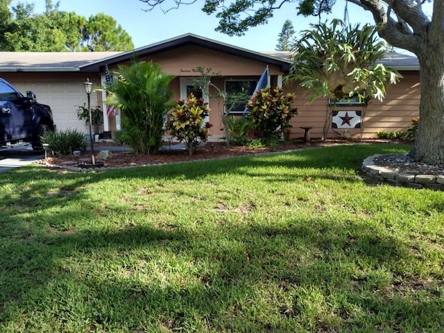 ranch-style house featuring a garage and a front lawn