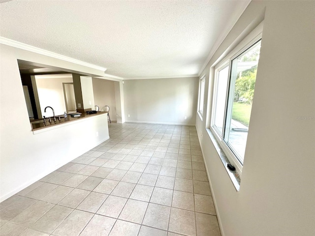 unfurnished living room with crown molding, plenty of natural light, a textured ceiling, and light tile patterned floors