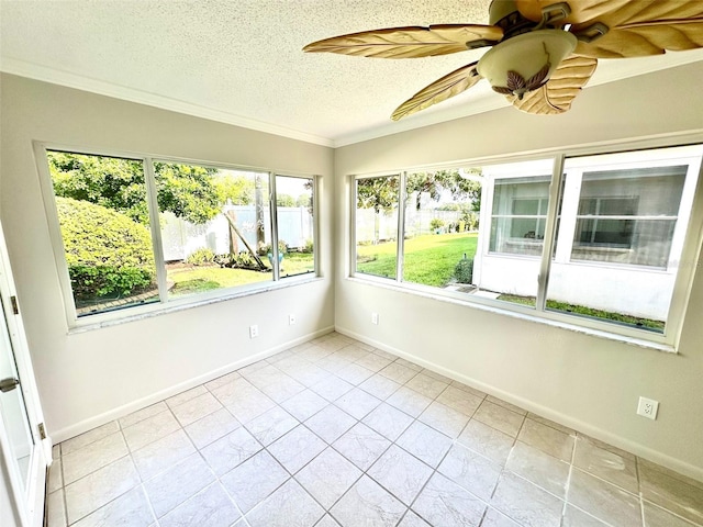 unfurnished sunroom featuring plenty of natural light and ceiling fan