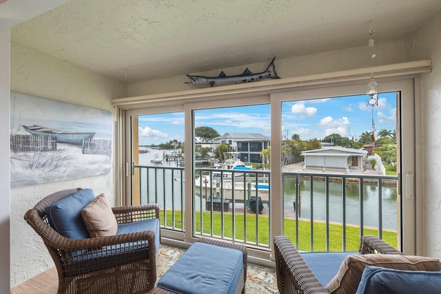 sunroom / solarium with a water view and a healthy amount of sunlight