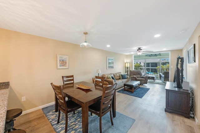 dining area with ceiling fan and hardwood / wood-style flooring