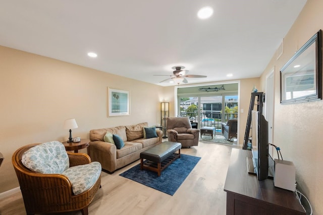 living room featuring ceiling fan and wood-type flooring