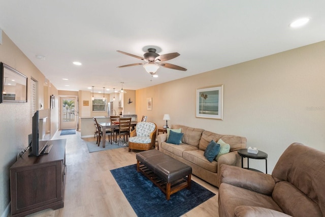 living room with ceiling fan and wood-type flooring